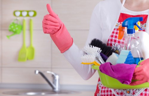 Professional using cleaning equipment with careful chemical handling